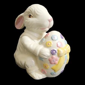 Vintage white ceramic Easter Bunny holding a decorated Easter egg